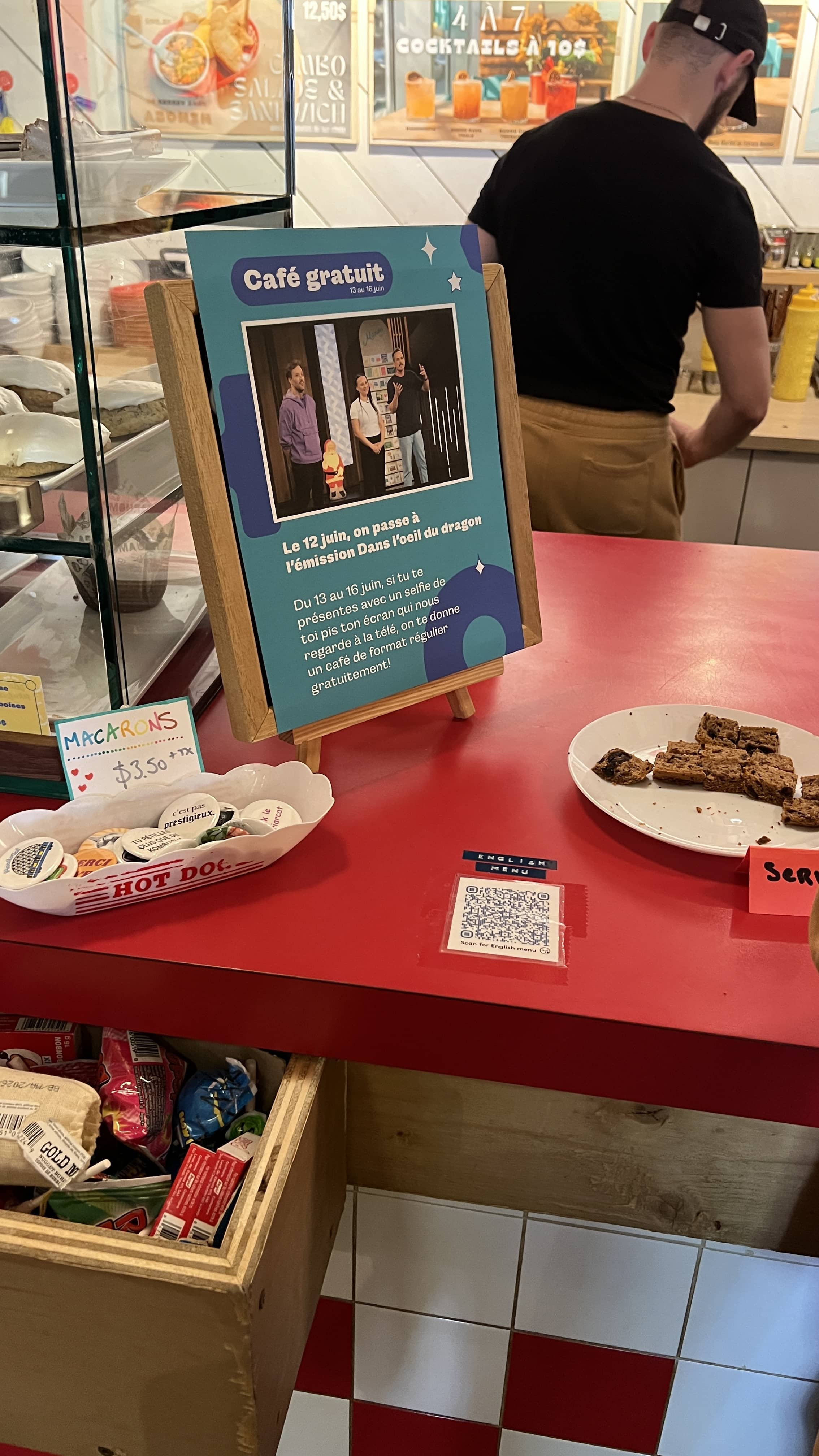 Café counter with a sign mentioning how the café is gonna be a venture capitalism reality tv.